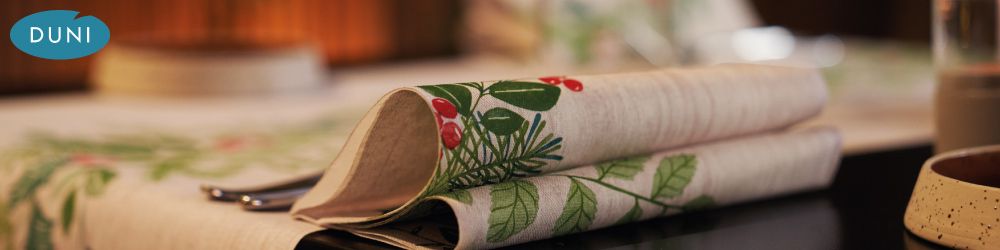 Duni Winter Greenery - Duni Winter Greenery. Christmas napkins, slipcovers, tete-a-tete rolls and placemats from Duni. Bring the festivities inside with this Nordic winter inspired design. Combine with fresh greens and rich red to give a rustic look that is rich in details.